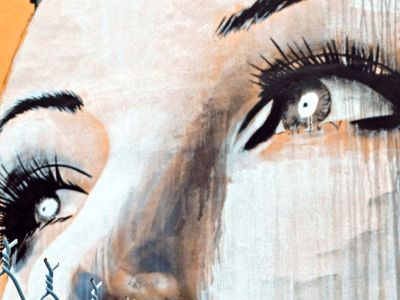A close up of a painting of a woman's eyes